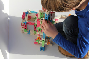 boy playing with wooden block toys from luco toy